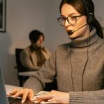 Professional woman wearing headset working in customer support, focused on her tasks.